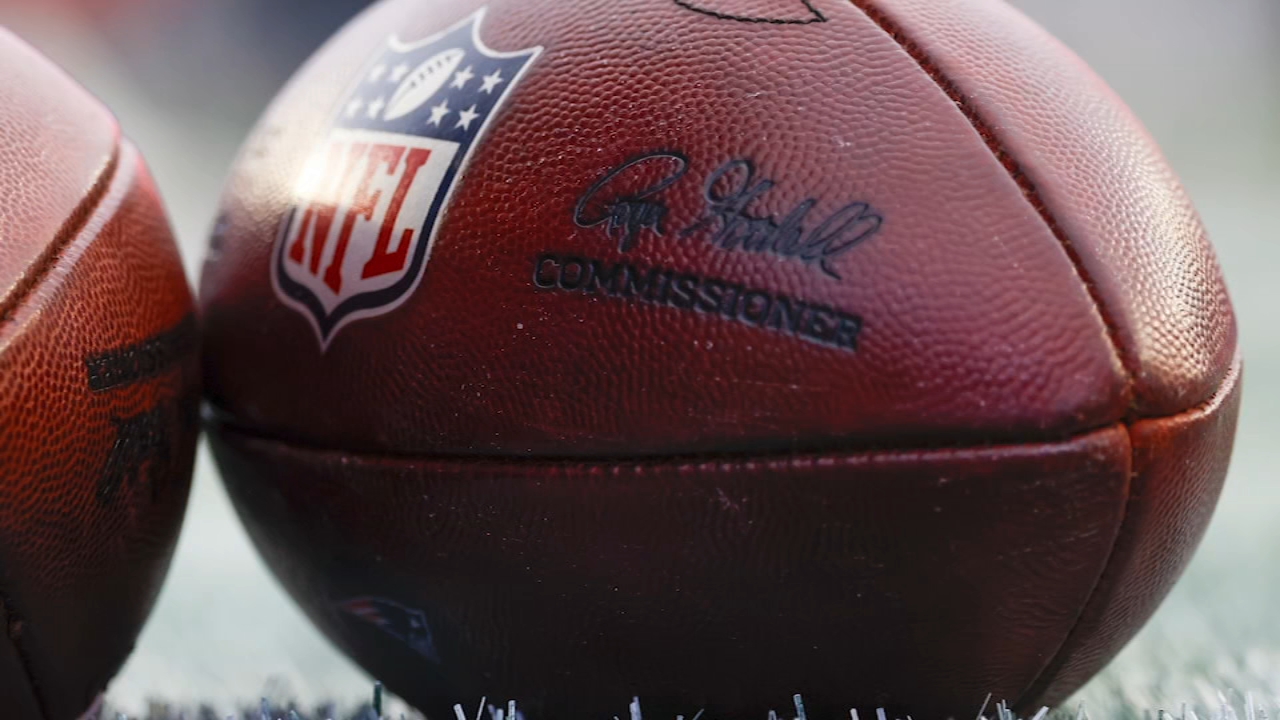 Former NFL player helmet on a field, symbolizing the hidden risks of professional football.